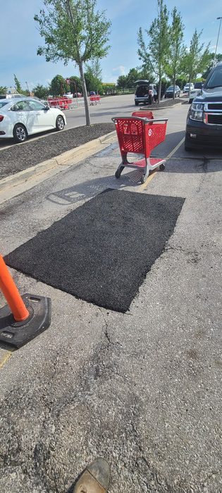 New asphalt patch repair in a retail parking lot