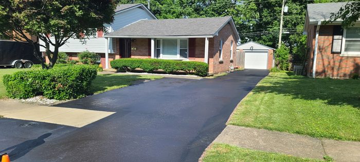 Freshly sealcoated blacktop driveway