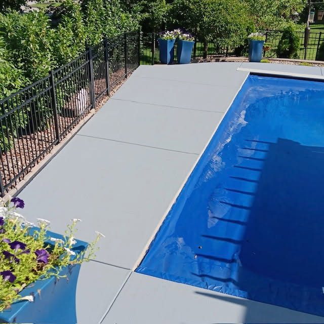 Gray coated concrete pool deck