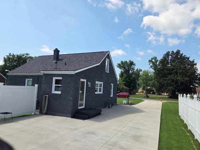 Brick home exterior painted charcoal with white trim