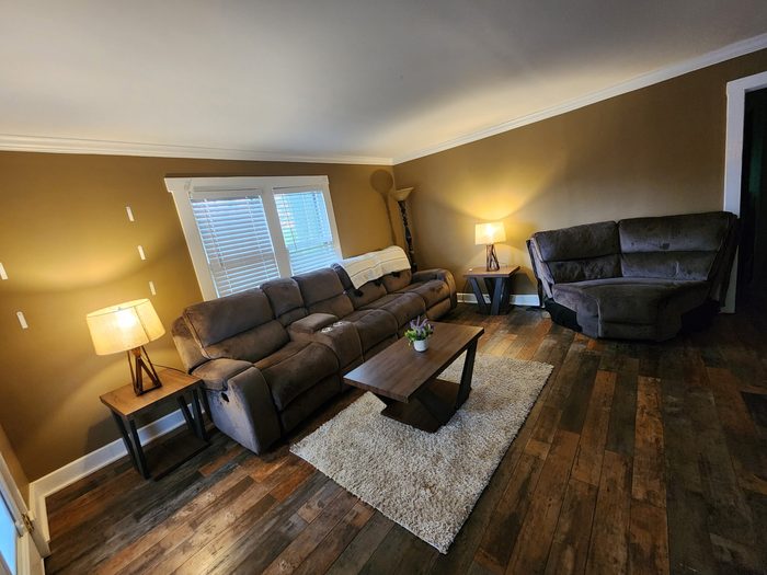 Living room repainted with white crown molding